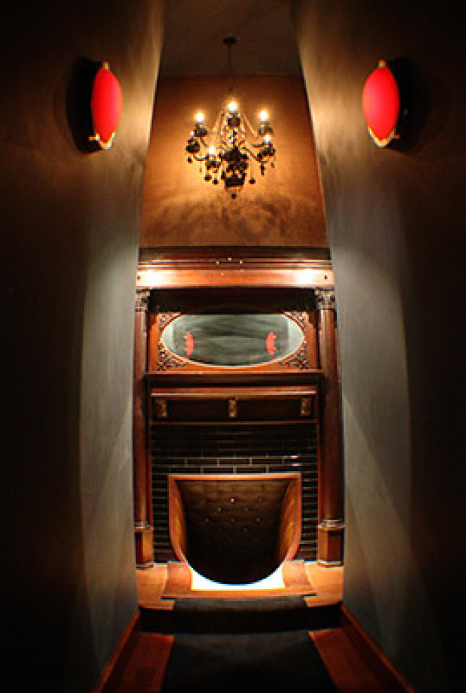 narrow hallway with a fireplace and a slide where it's hearth is