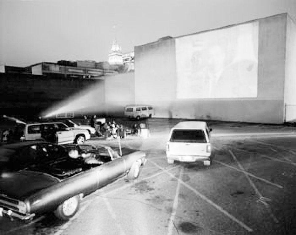 cars parked in lot watching film