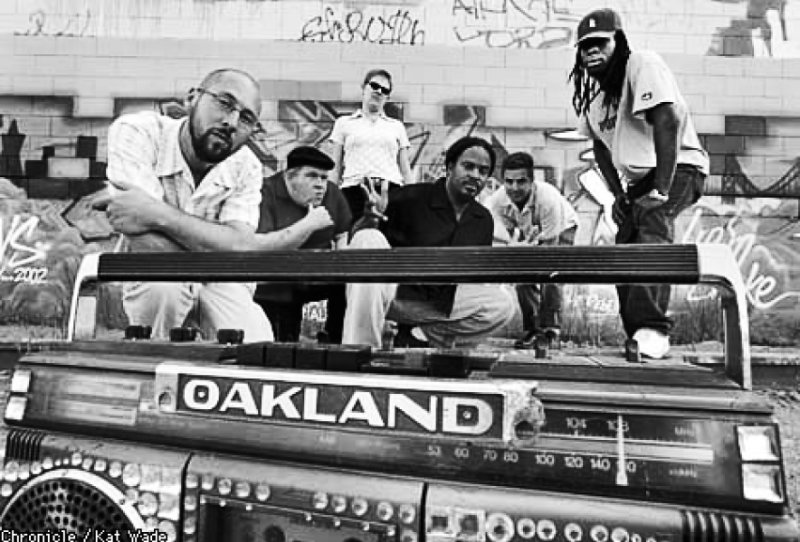 group of people behind a boombox that says Oakland